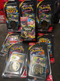 Six packaged Pokémon Perfect 5 Star Cards sets arranged on a dark carpeted floor. Each set is in its original black blister packaging with colorful card inserts and a gold-colored coin featuring the corresponding Pokémon logo.